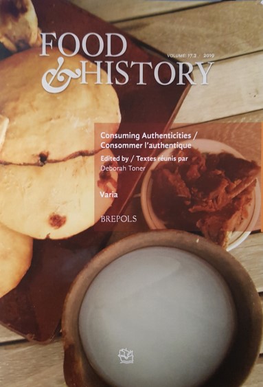 Cover of journal issue Food and History. A plate of pulque bread - lightly coloured buns on a dark plate - sit next to a bowl of pulque, a white coloured liquid, and a plate of conserves.