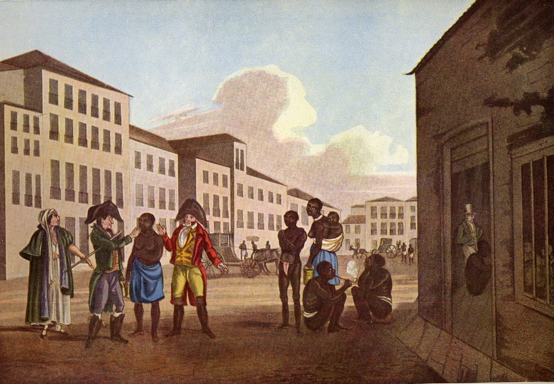 Colour painting. Enslaved men, women and children are in a public street, partially clothed, while well-dressed people of white complexion appear to be exchanging one of the enslaved people. The street is lined with multistory buildings, horses and carriages in the backgroud